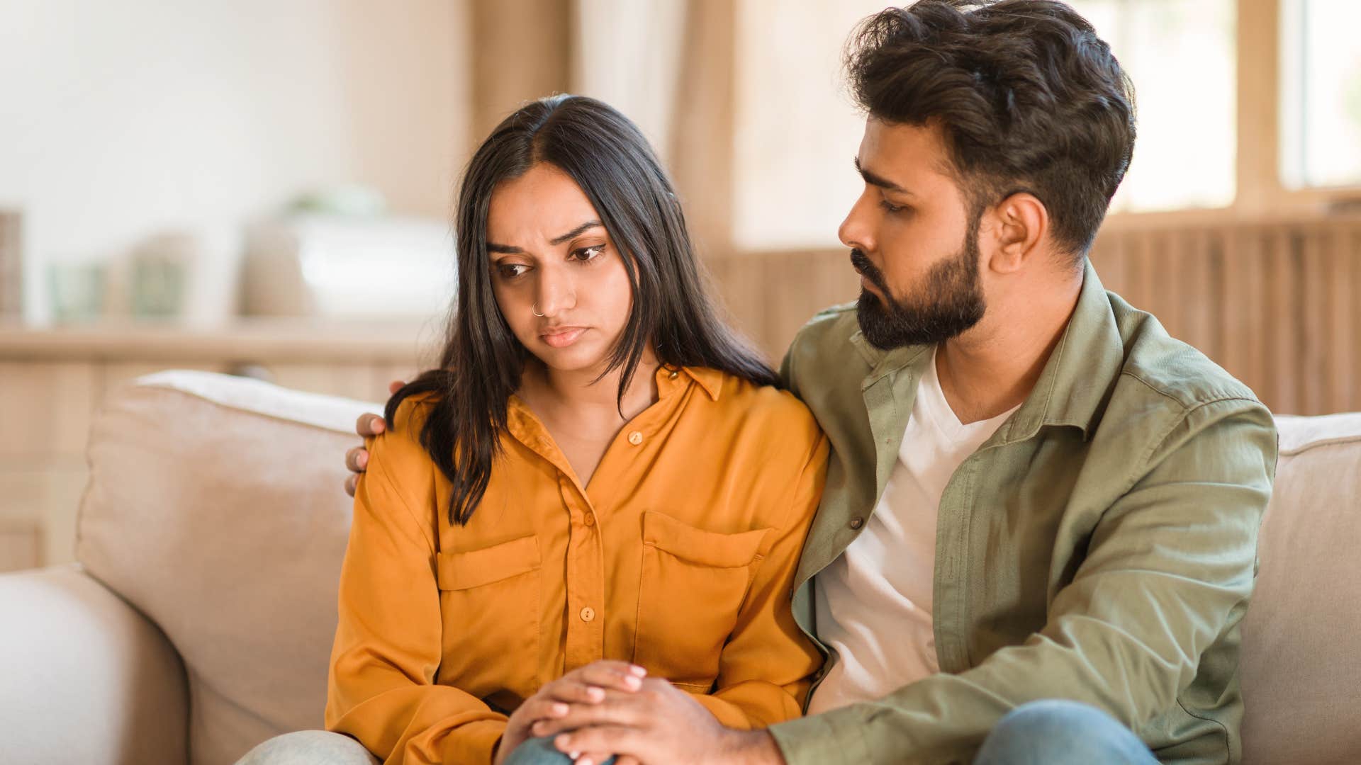 man asking upset partner if they can just enjoy the moment
