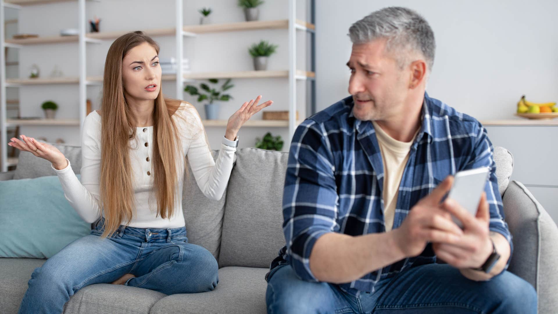 woman upset with man texting another woman