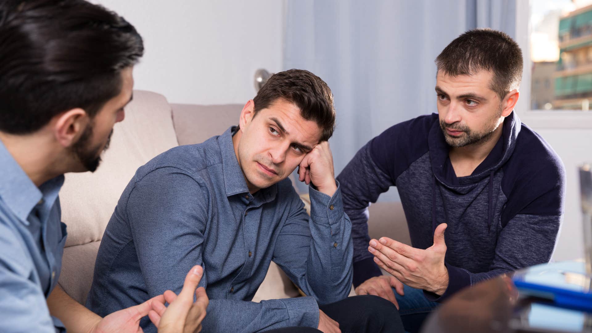 man talking with friends about his partner