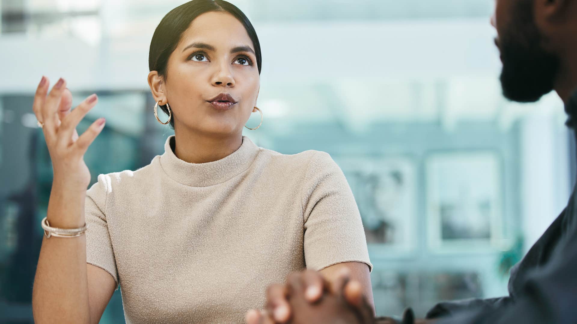 defensive woman defending her perfectionism to colleague