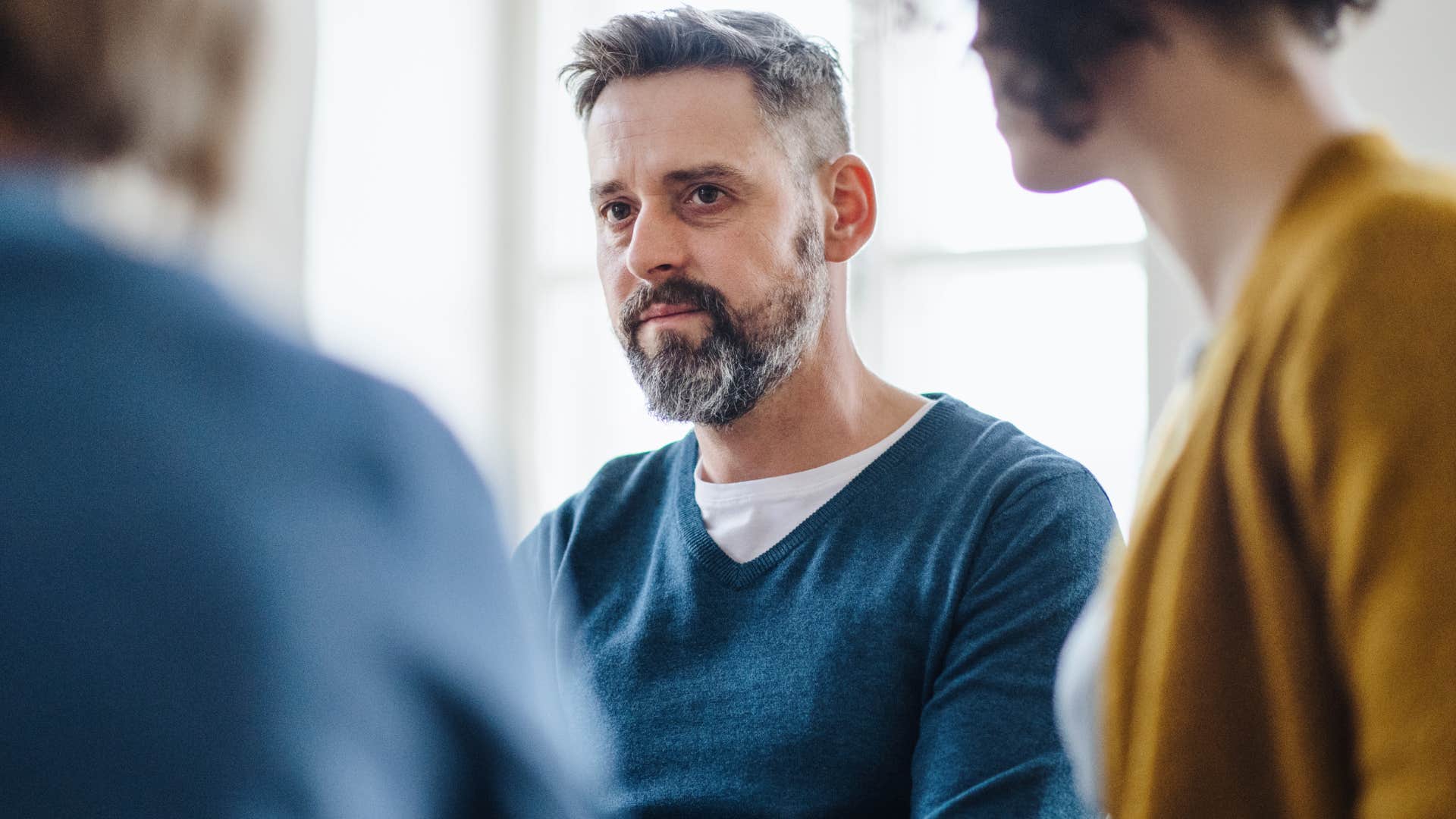 emotionally unregulated man talking to friends
