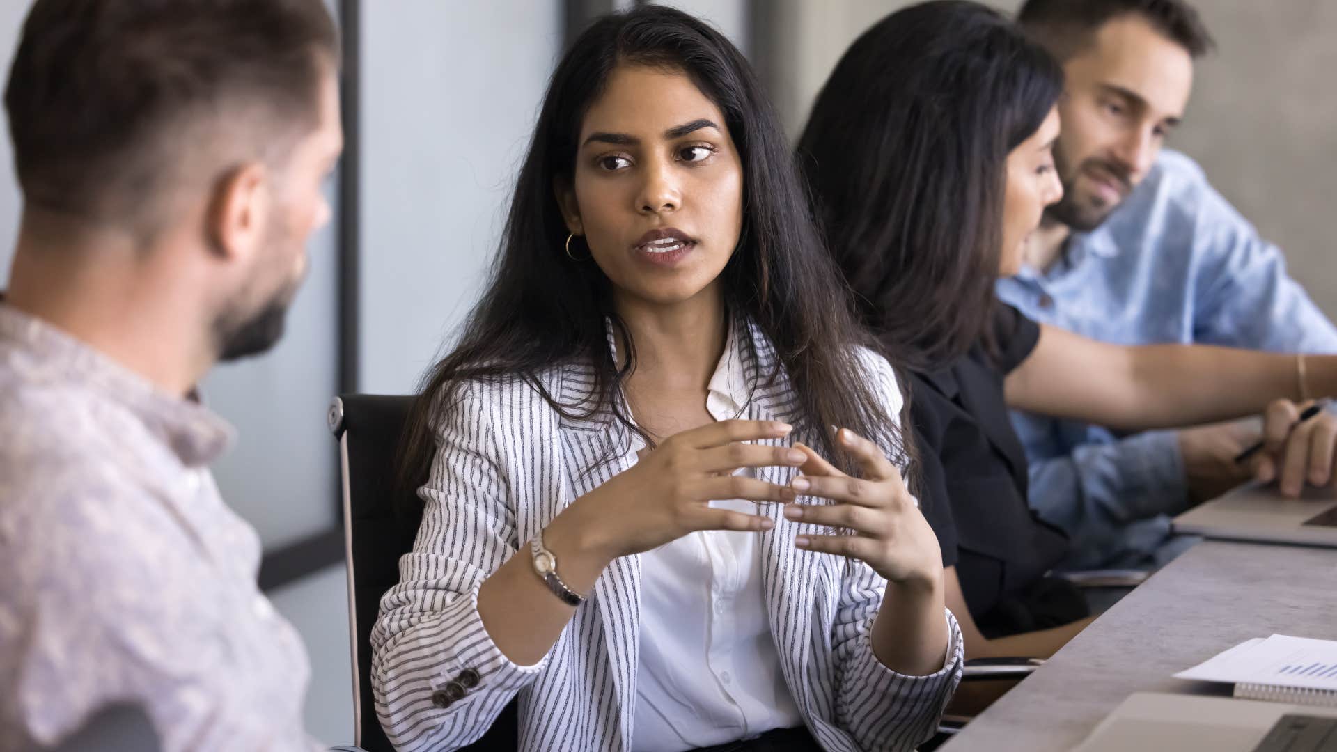 defensive woman dealing with imposter syndrome at work