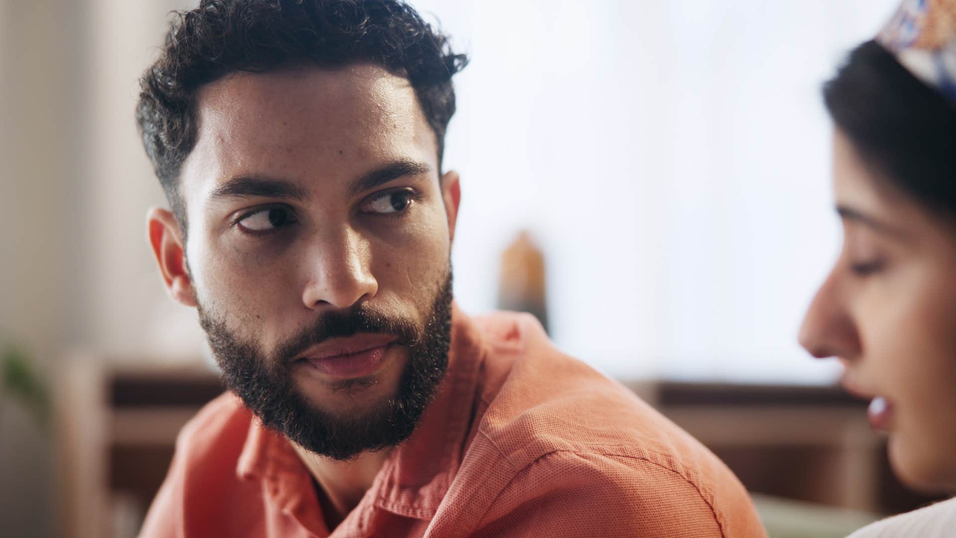 defensive man with lingering unresolved childhood trauma talking to his partner