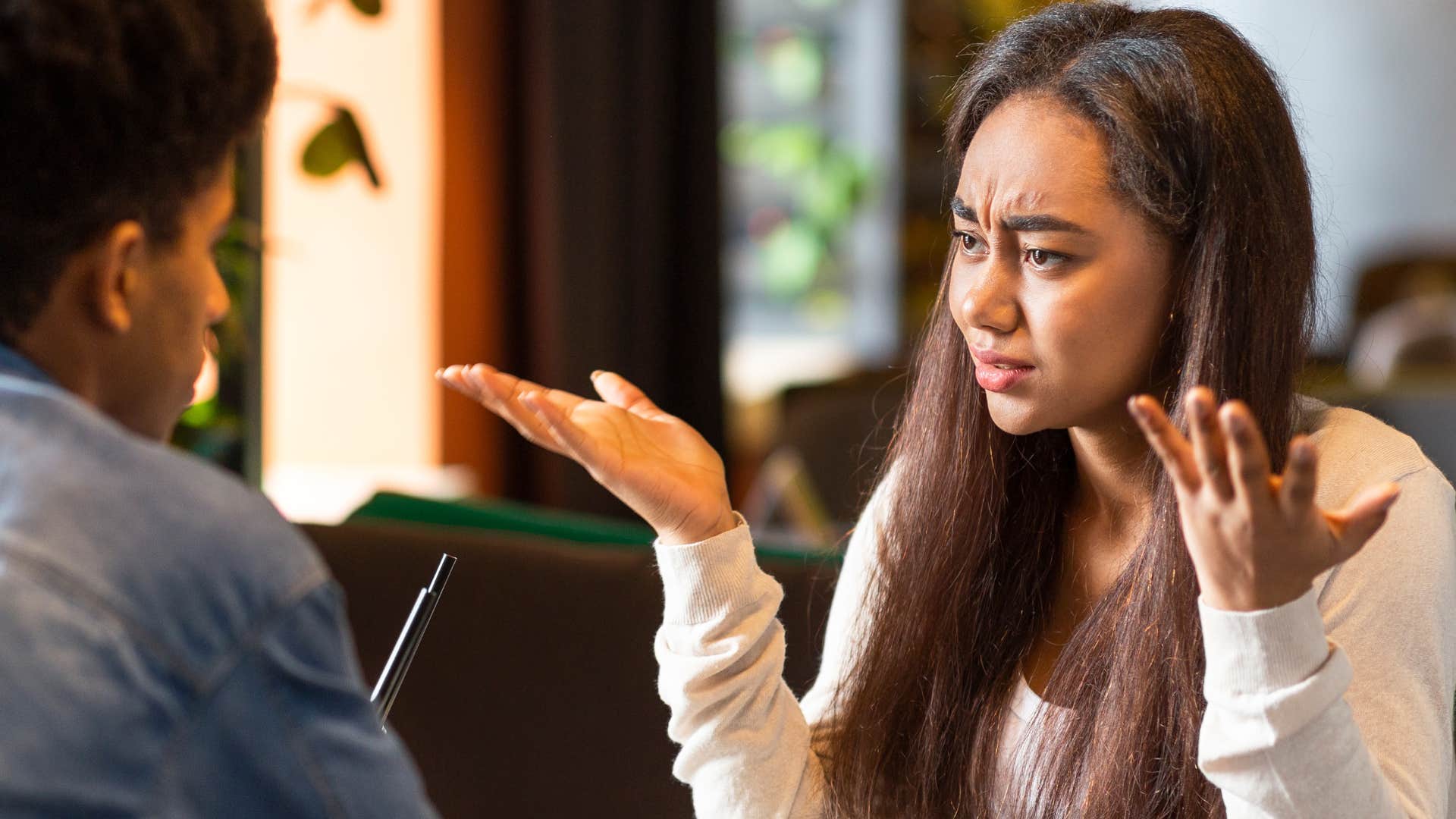 rude woman shrugging saying I didn't ask to her partner