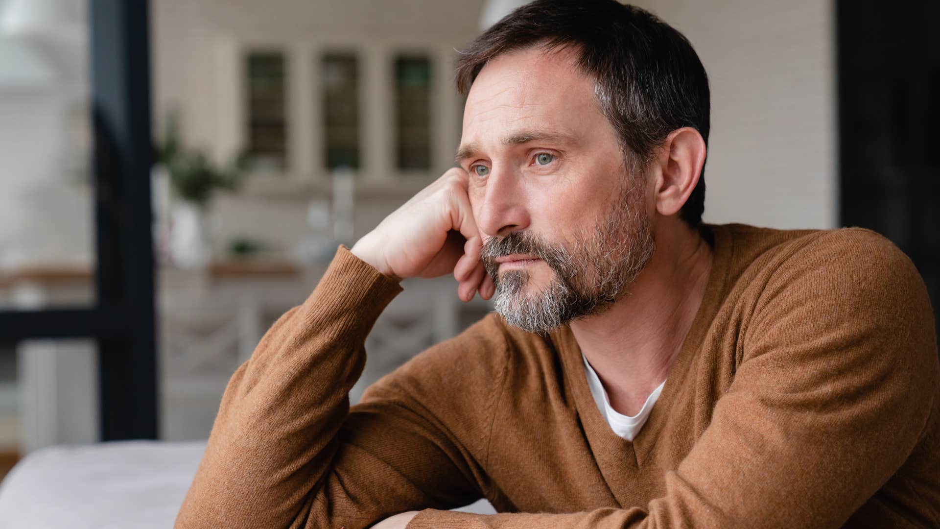Man who feels emotionally fragile sitting at home.