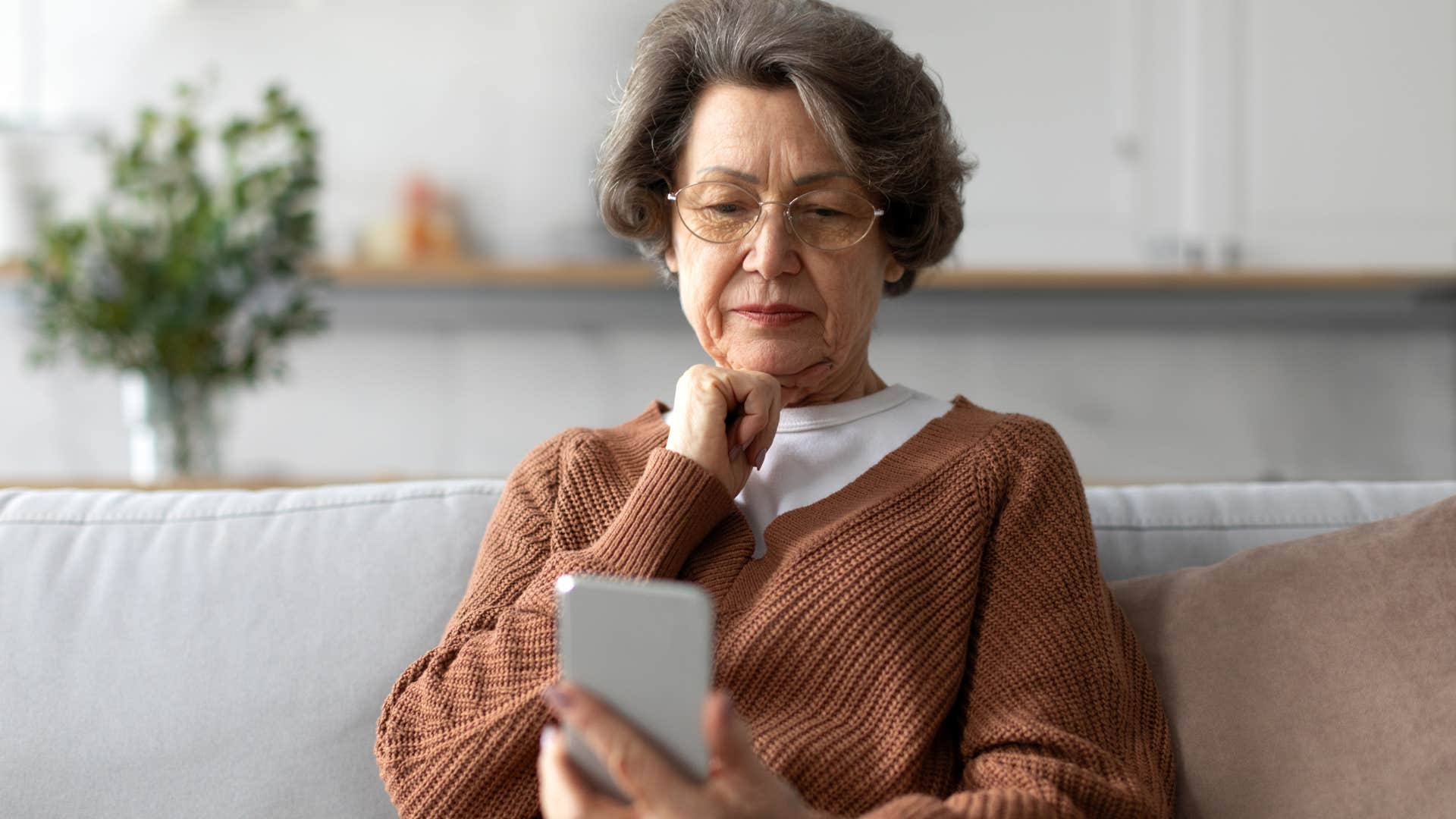 Woman who's feeling invisible looking at her phone.