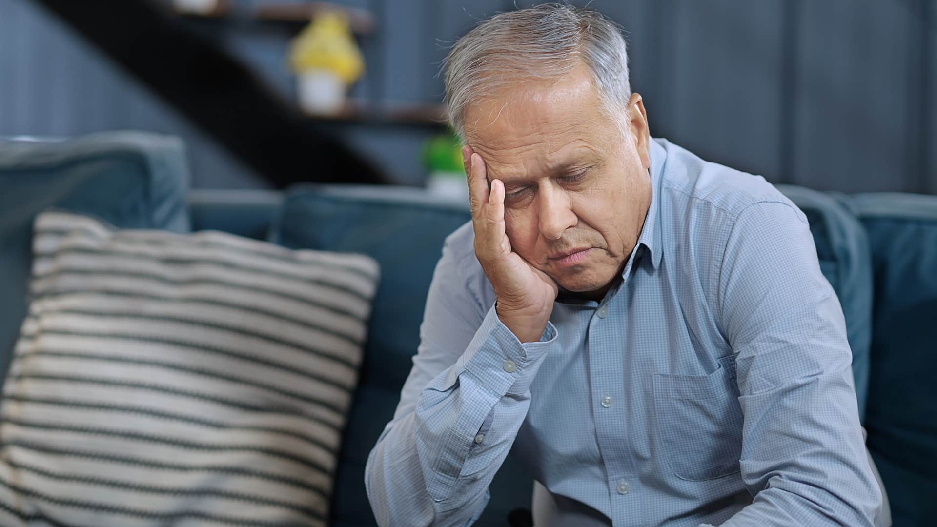 Man who's lonely sitting on the couch.