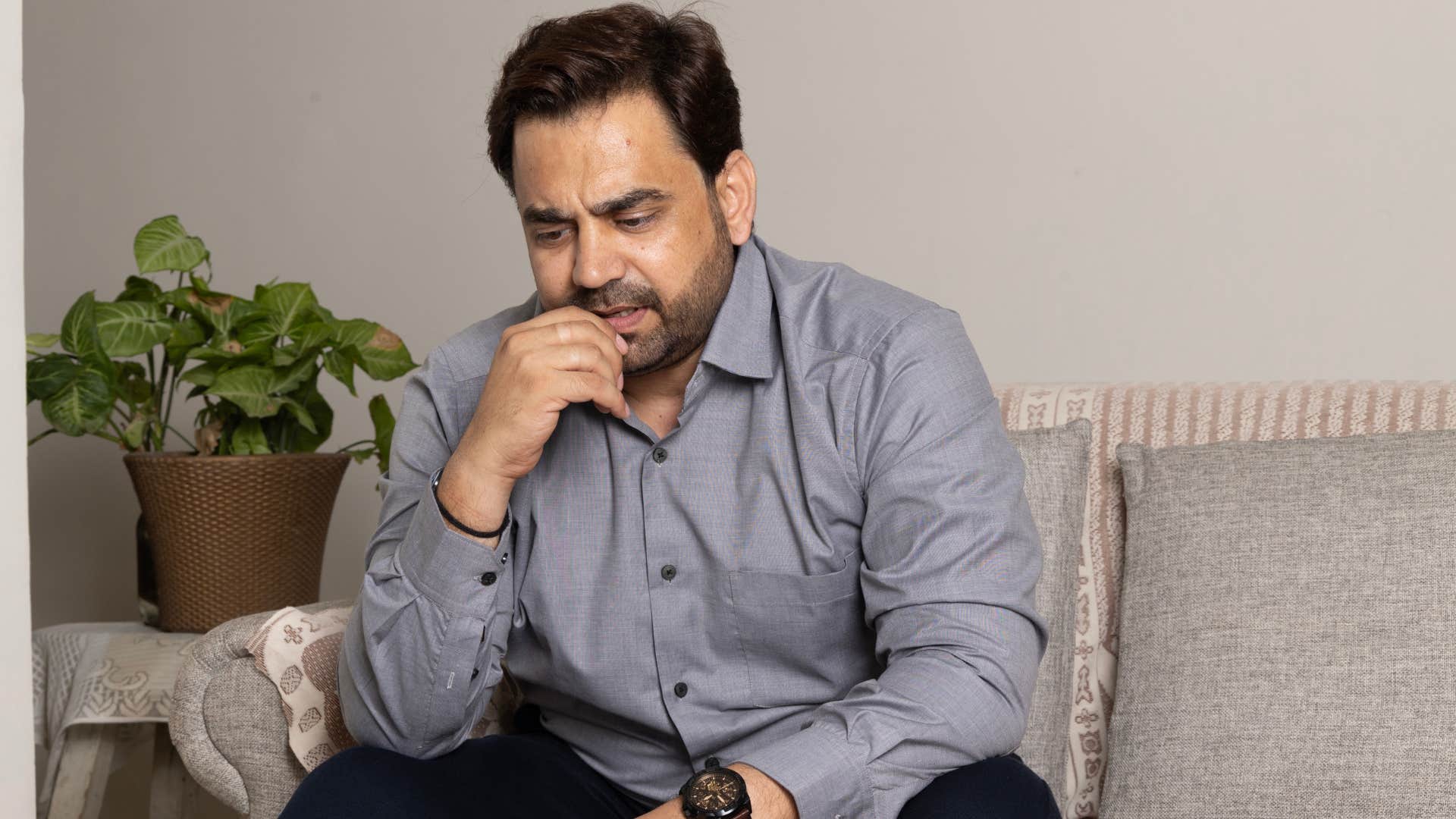 Man who's stuck in fight or flight sitting on the couch.