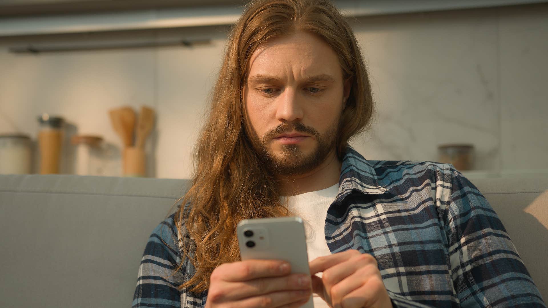 man looking at phone avoiding someone online