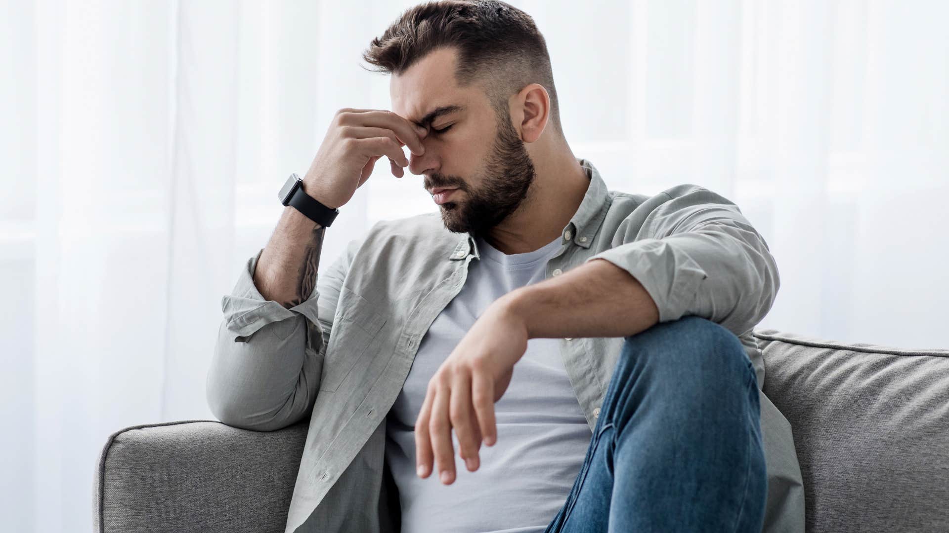 sad man who's consistently depressed and anxious sitting alone