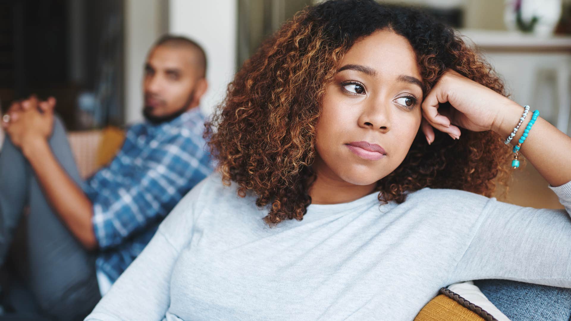 woman stuck in a toxic relationships turned away from her partner