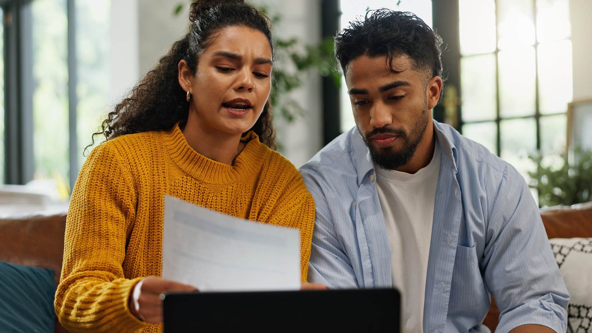 couple splitting expenses down to the last looking at bills