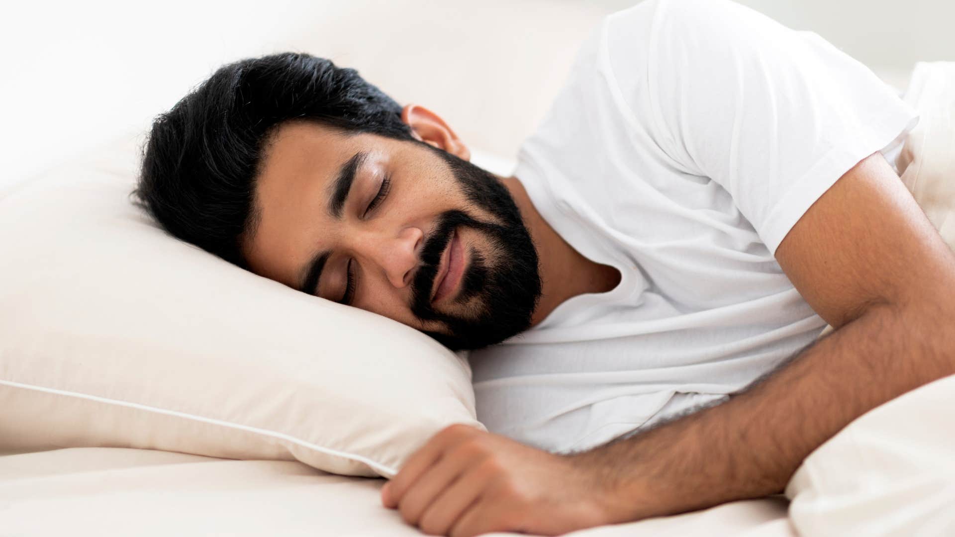 man cuddling with pillow from childhood habit