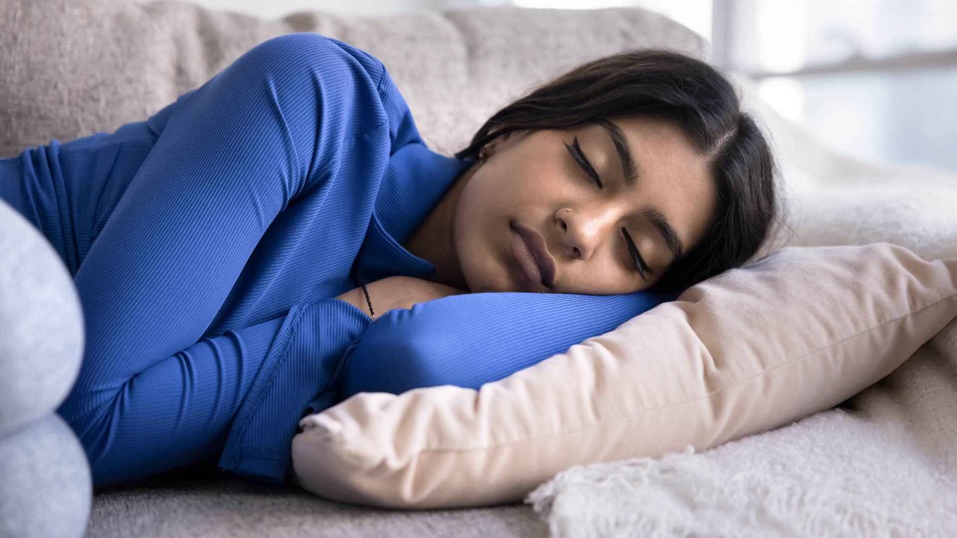 woman cuddled up on pillow craving comfort