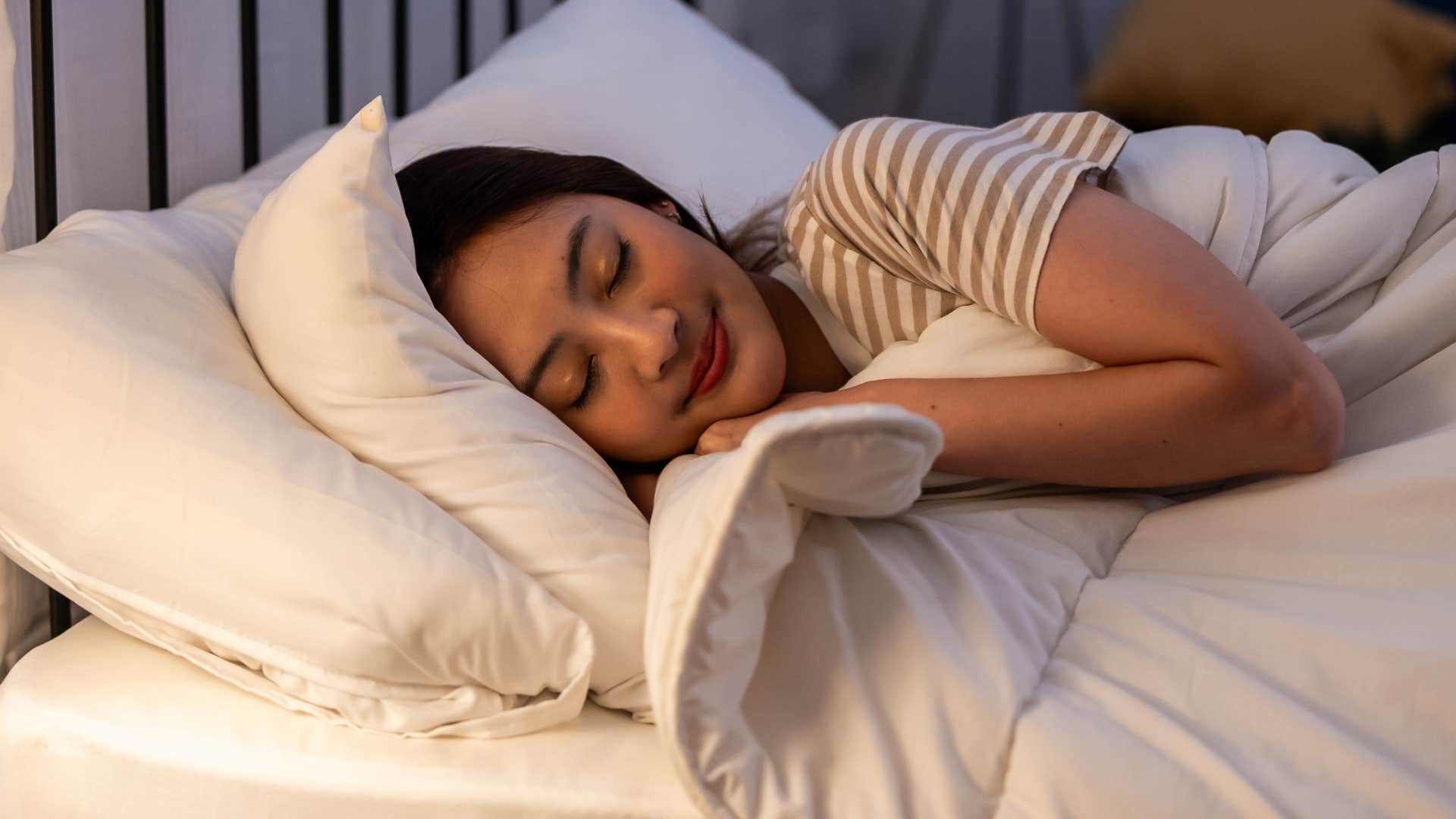 woman with an internal tenderness that hardly shows laying in bed