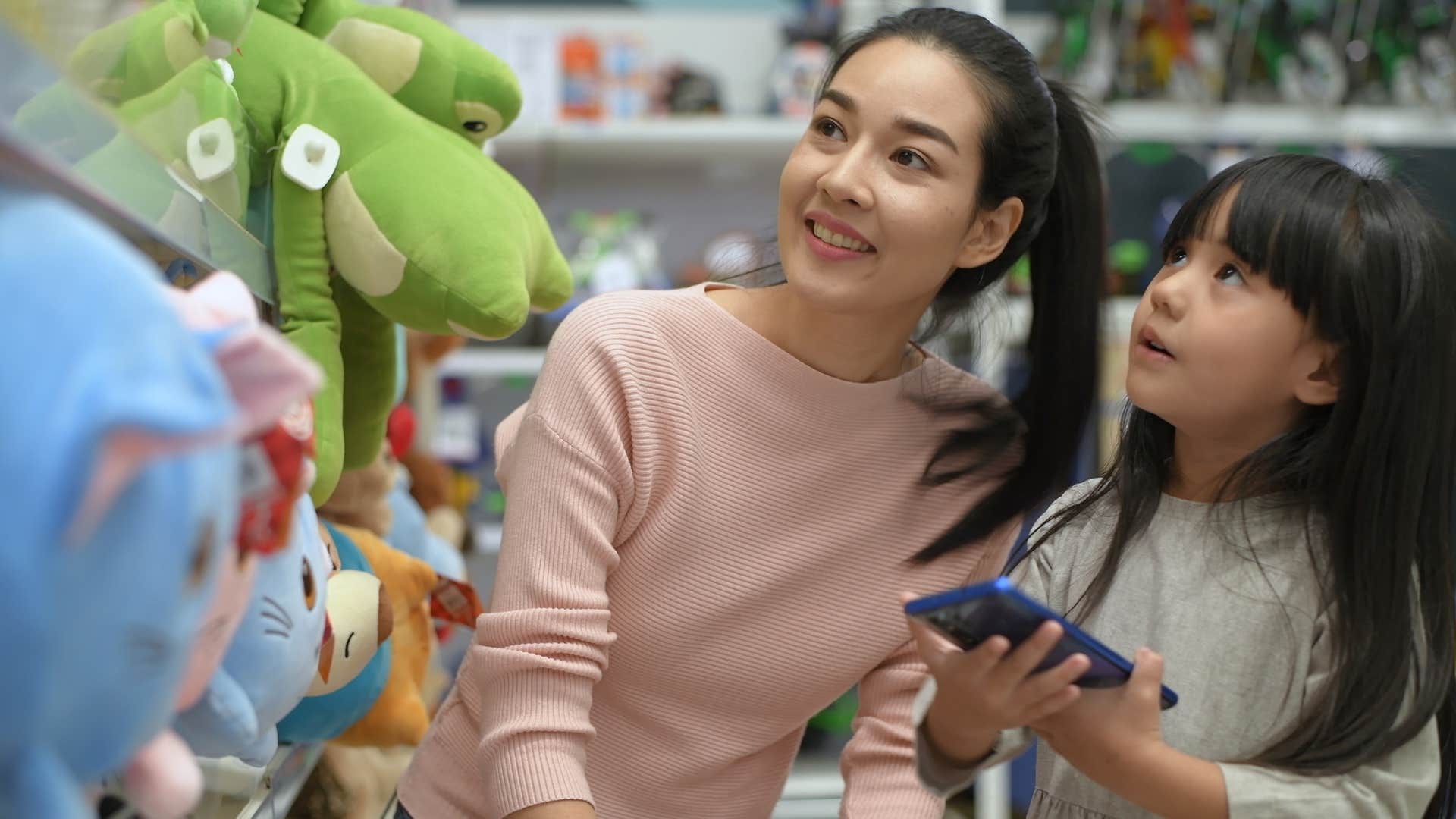 mom telling daughter maybe next time at toy store