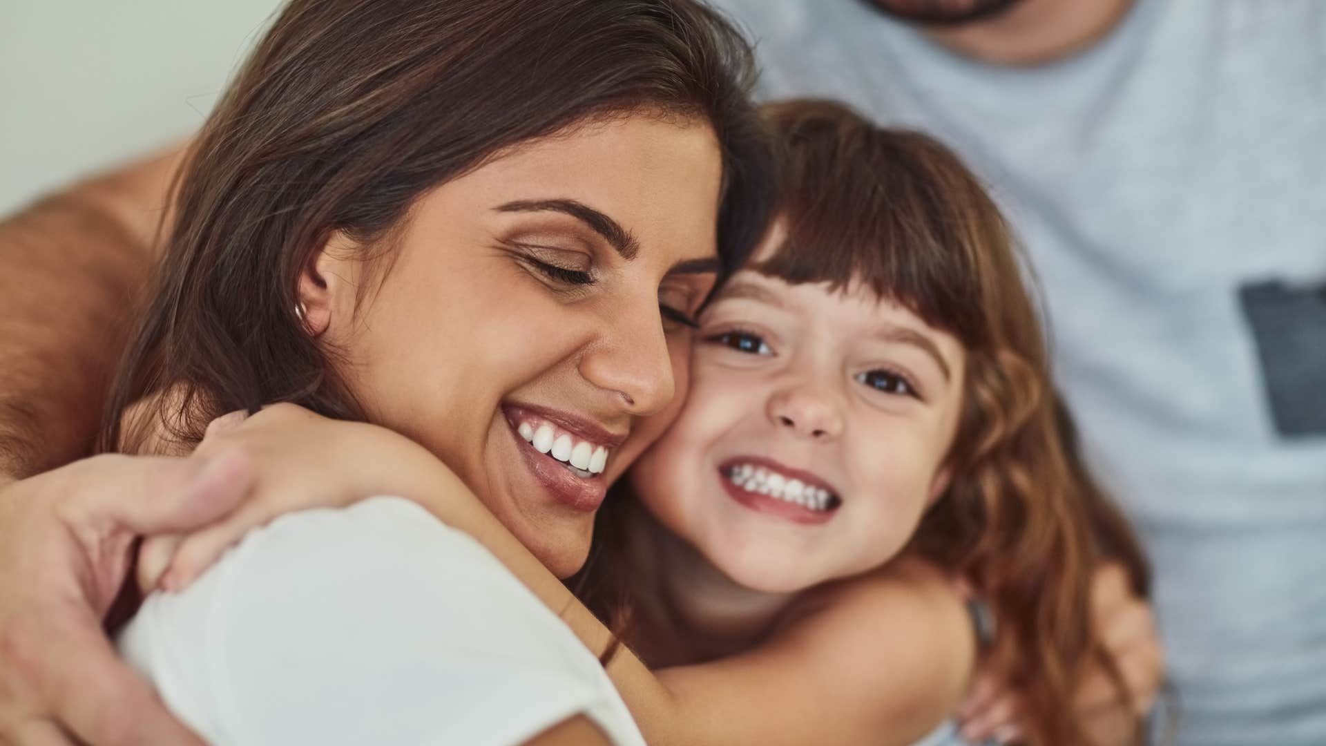 mom hugging her daughter saying as long as we're together we're rich