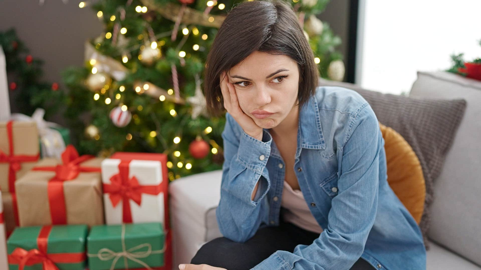 Woman sitting in her home with decorations from a season that already passed.