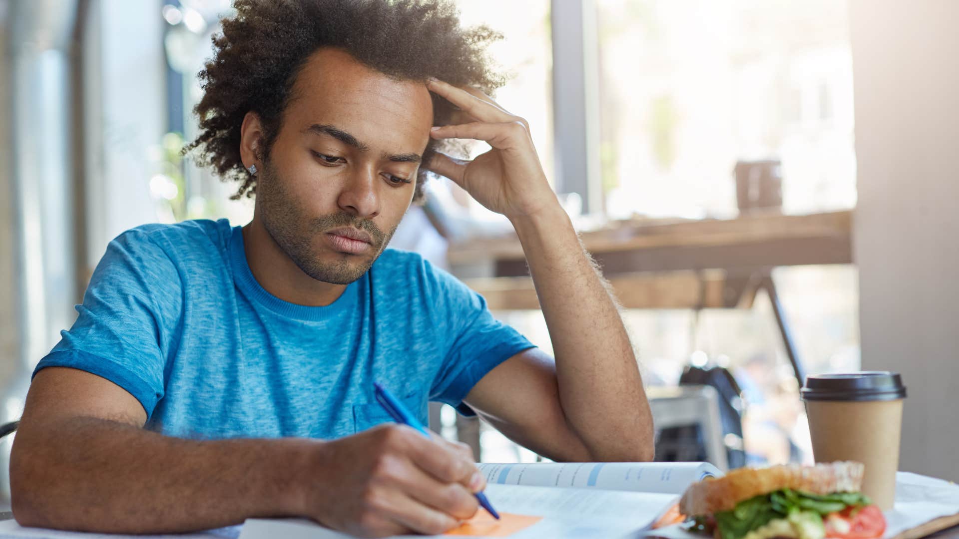 Man sitting with random sticky notes scattered around.
