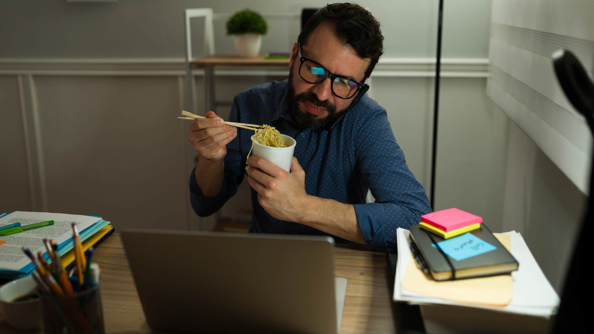 Man sitting with take-out containers overflowing from the trash.