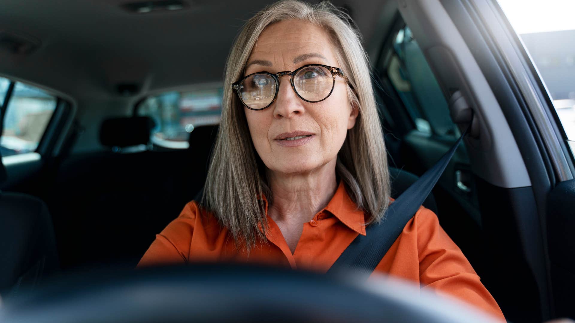 woman sitting in a car that's always silent