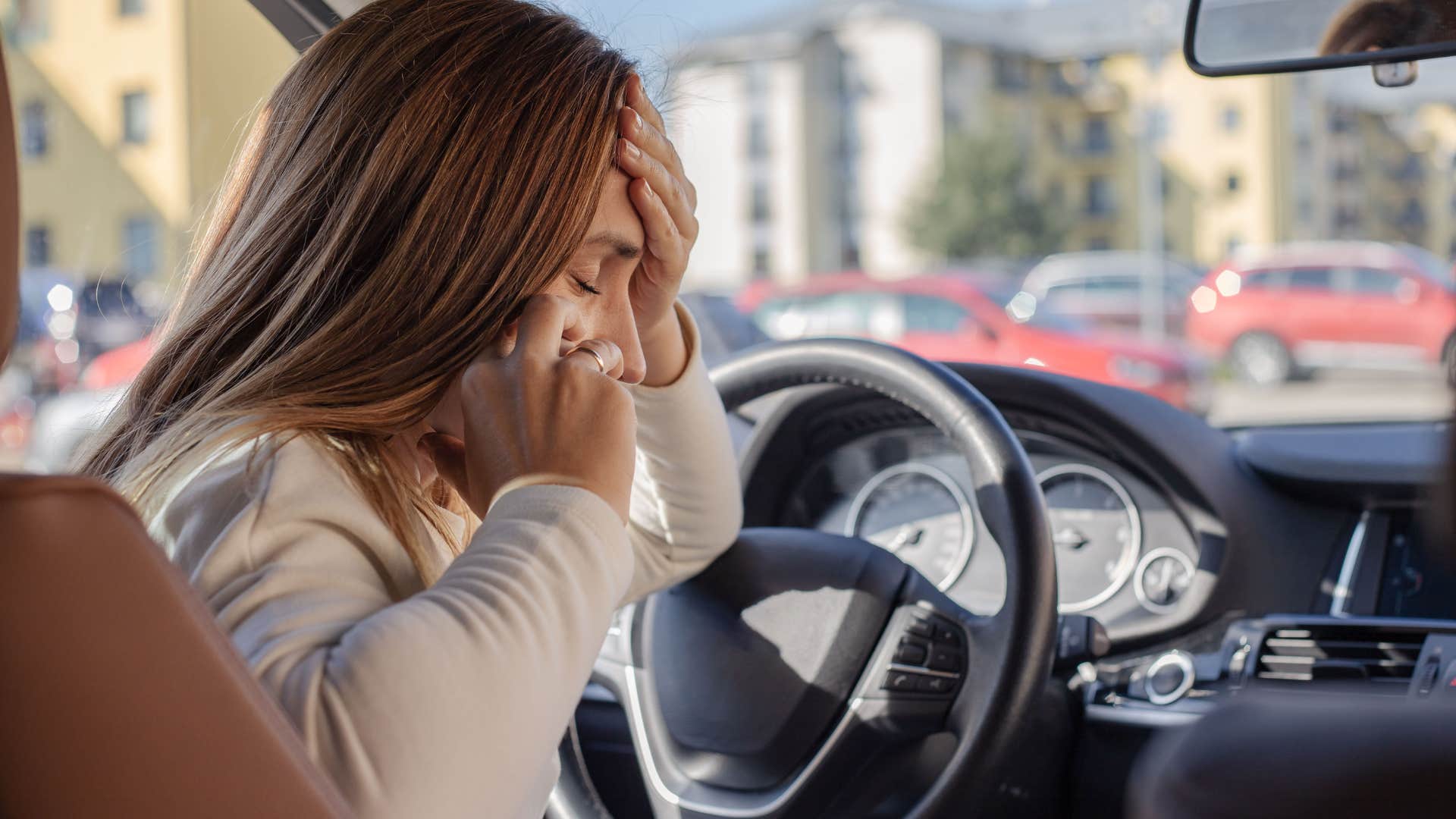 woman frustrated with a broken phone charger in her car