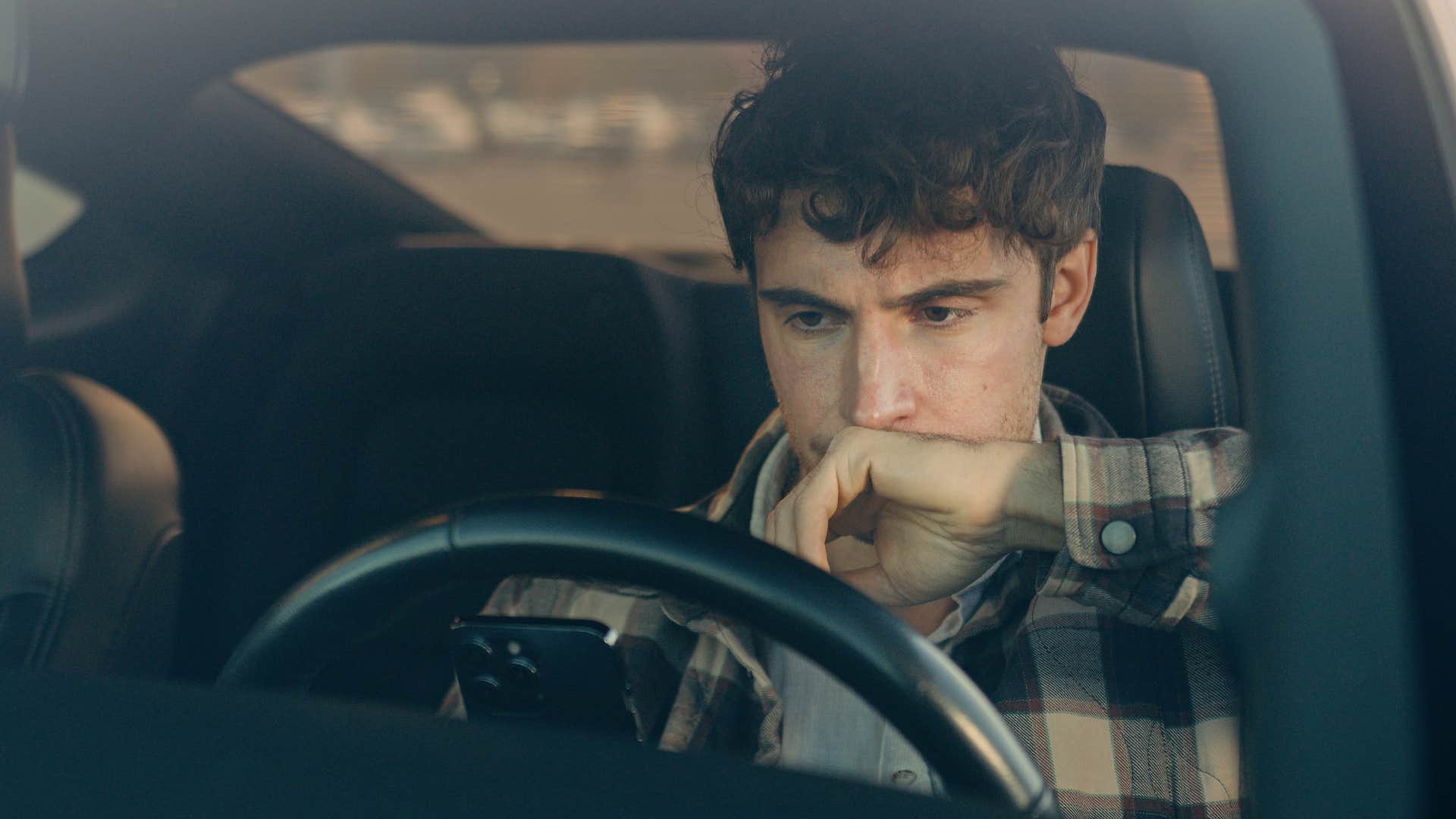 man with an expired registration tag sitting in his car