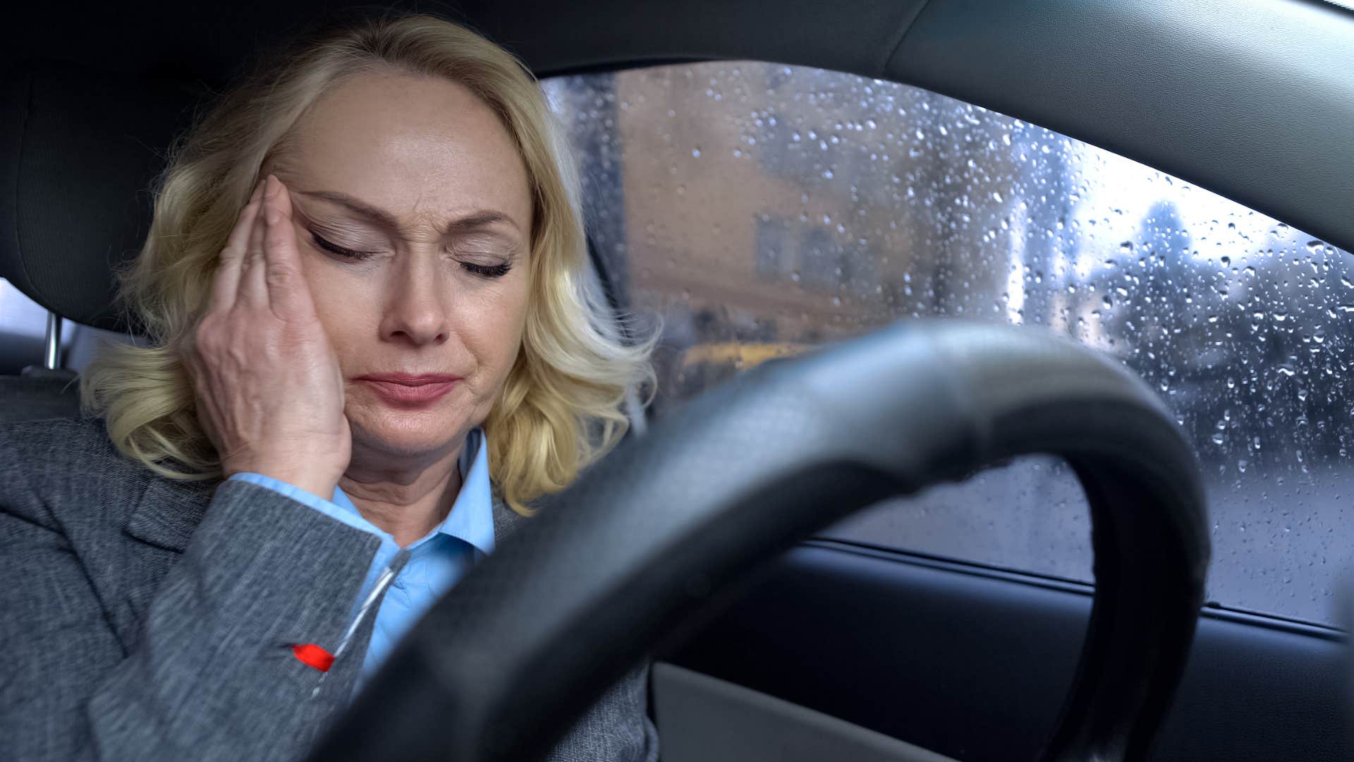 stressed woman with random comfort objects in her car