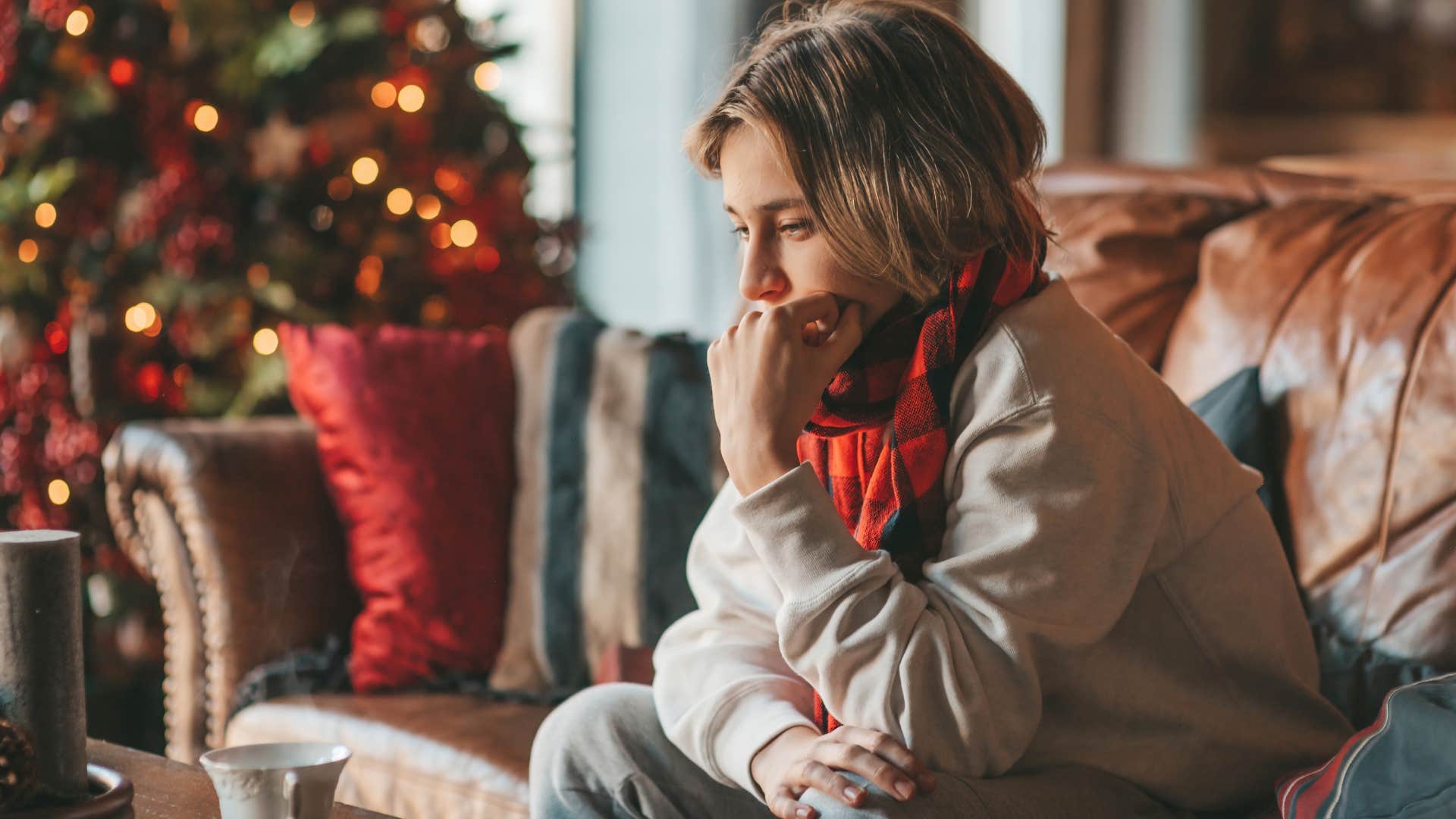Woman sitting in her living room with seasonal decor still up.