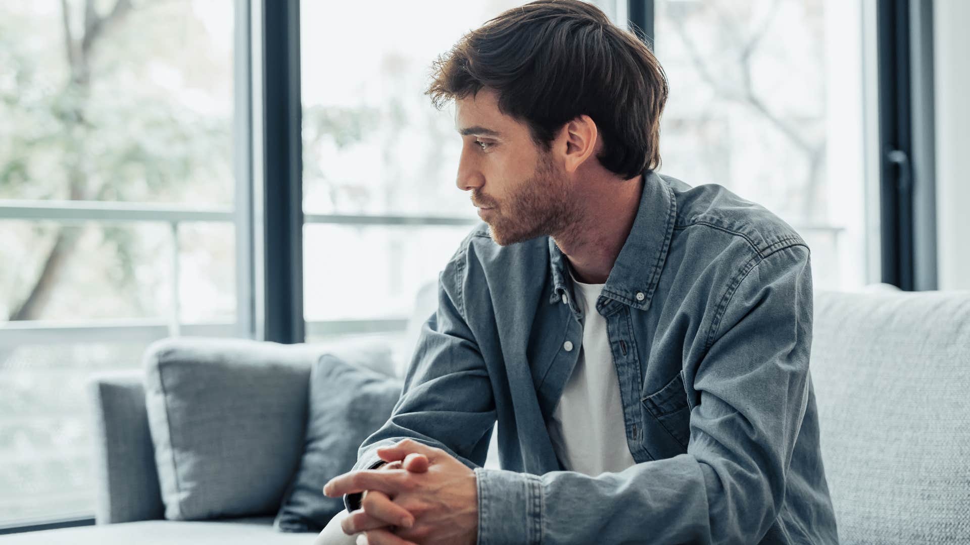 man sitting at home where there's no decor