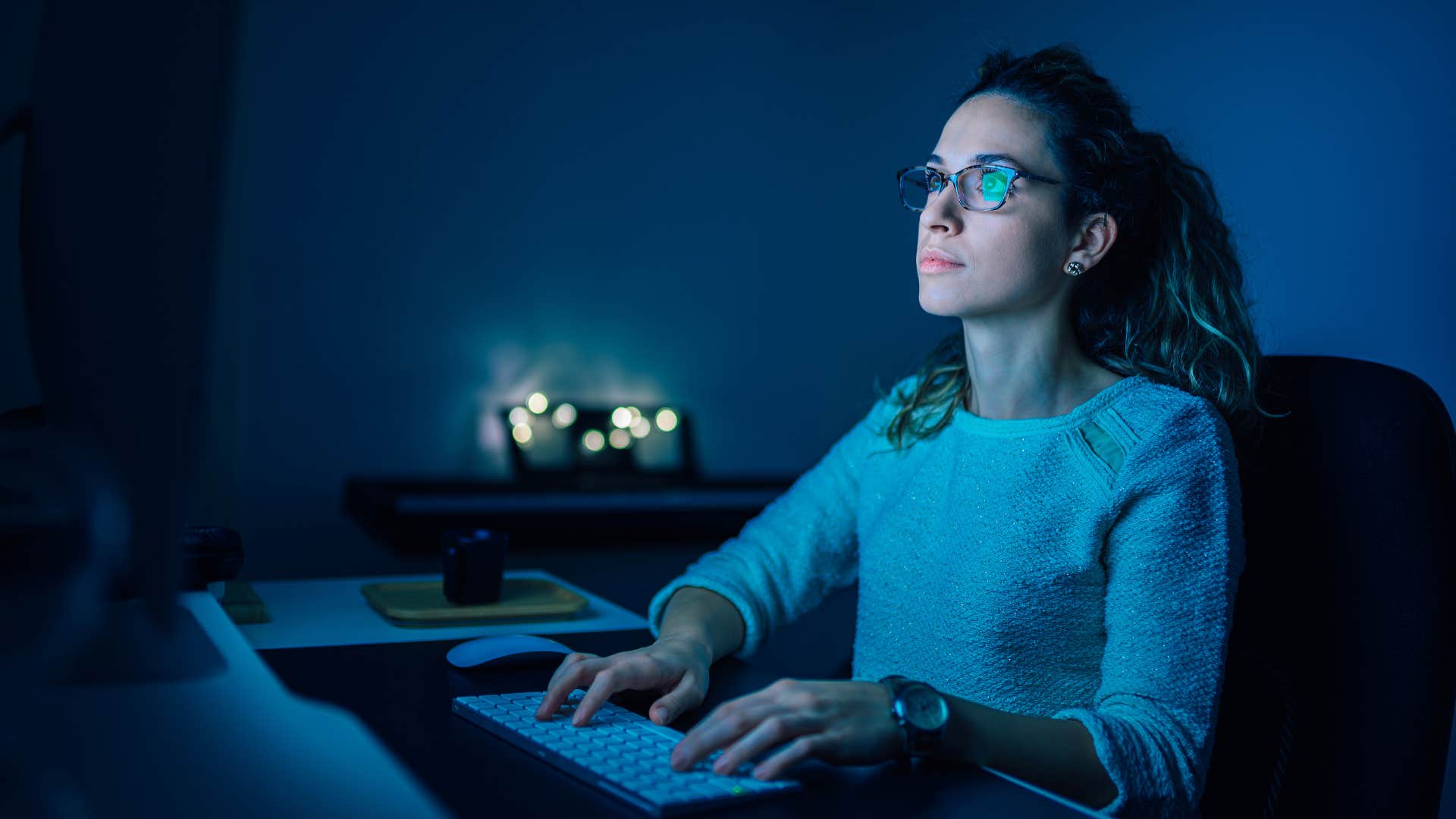 woman staying up at night working on laptop
