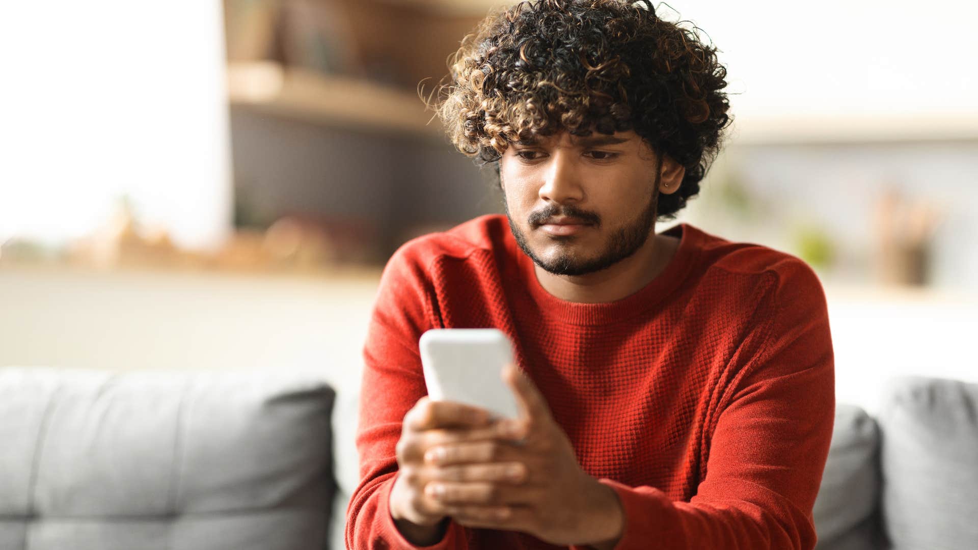 man whose become dependent on distraction looking at his phone
