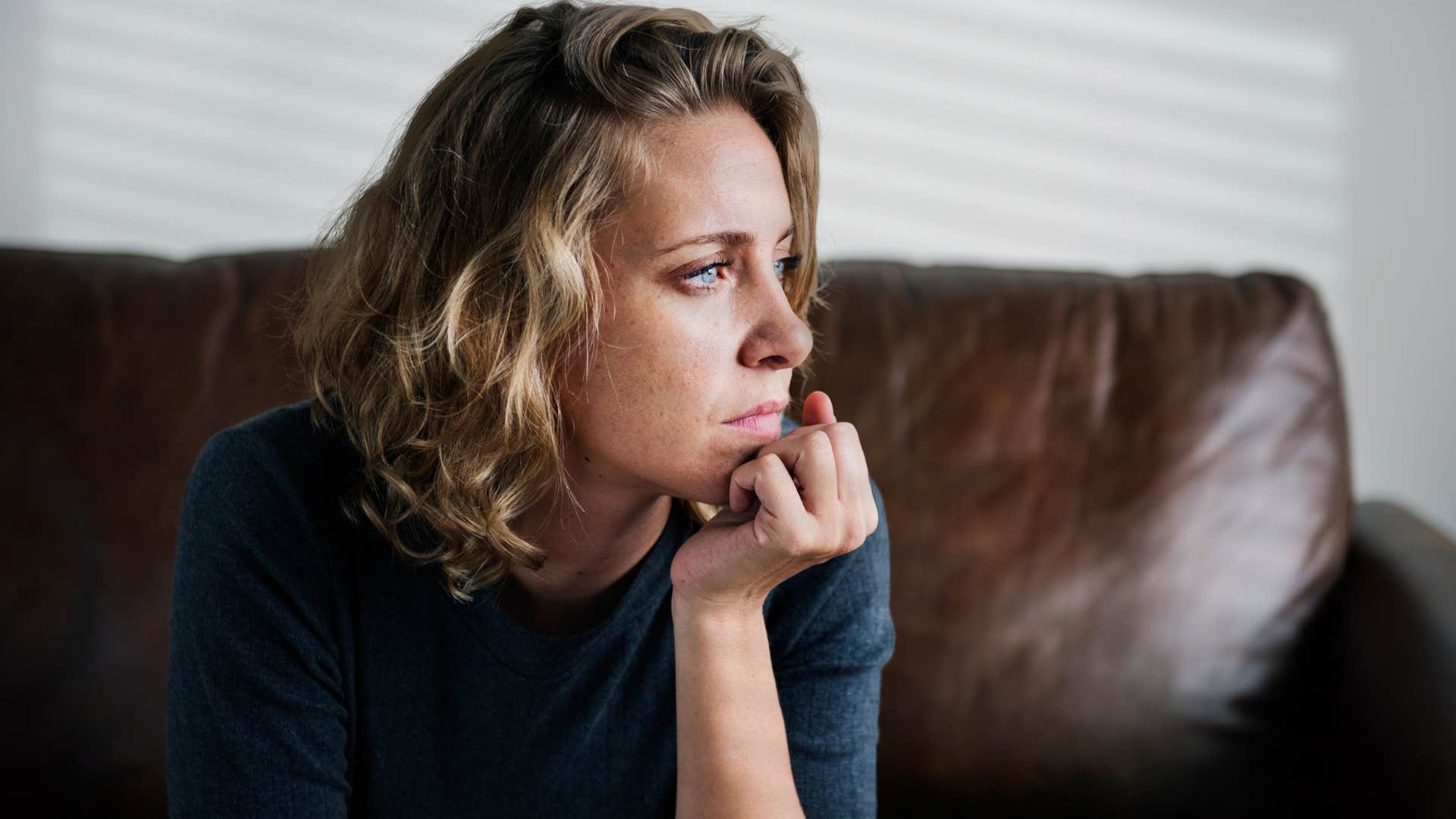 sad woman who doesn't want pity sitting at home