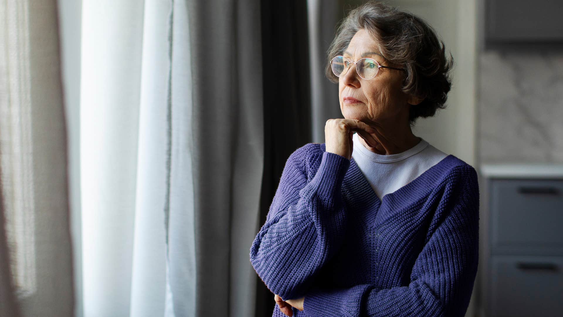 perfectionist woman looking out a window