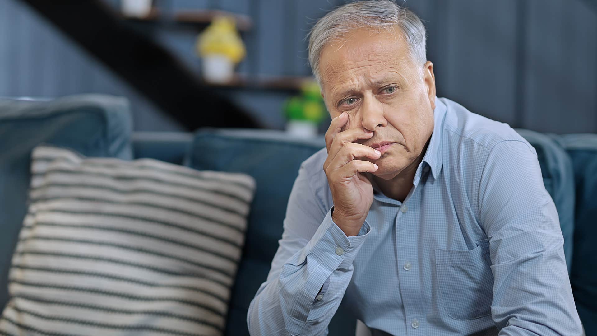 upset man whose been through worse sitting at home