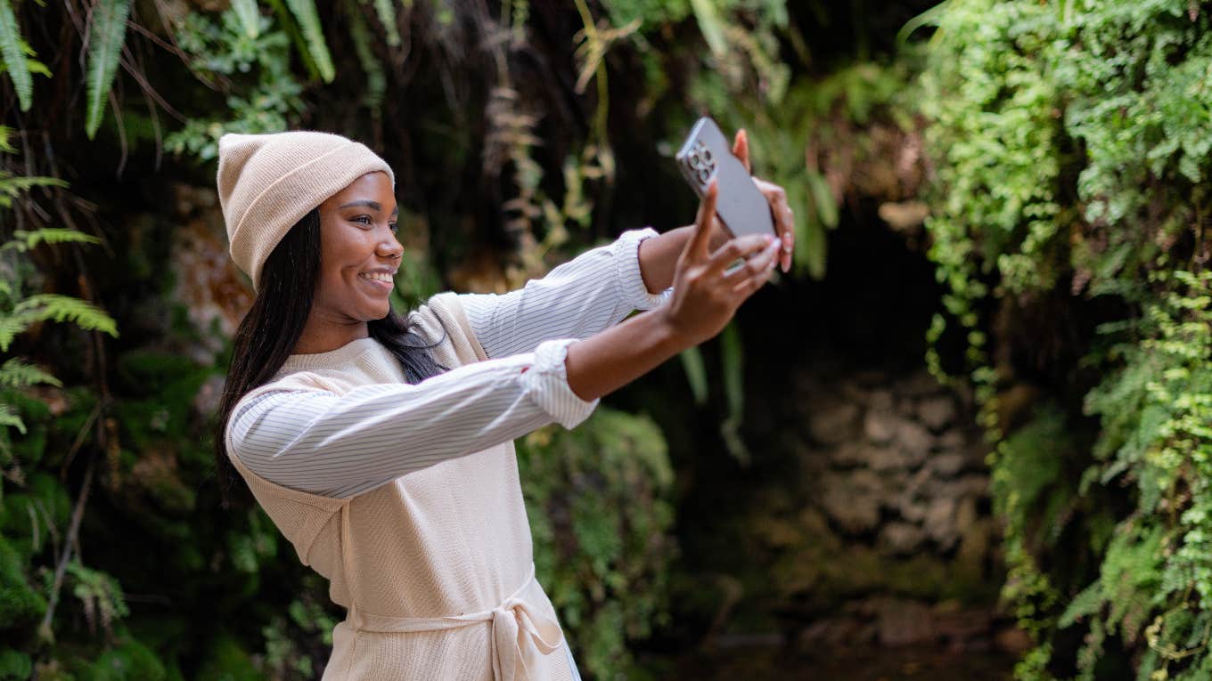 woman taking a selfie to change her profile picture