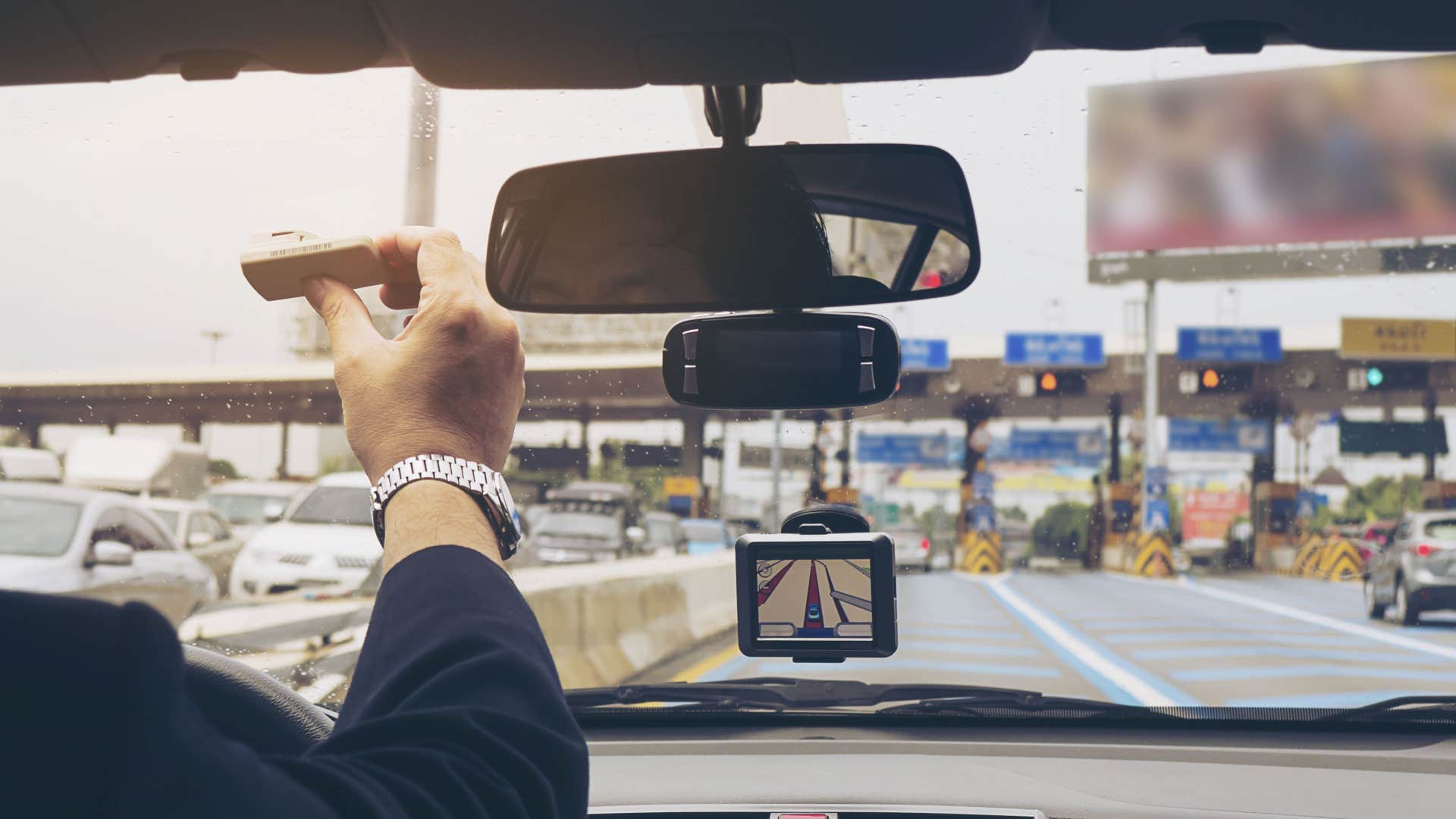 electronic toll transponder in a man's car