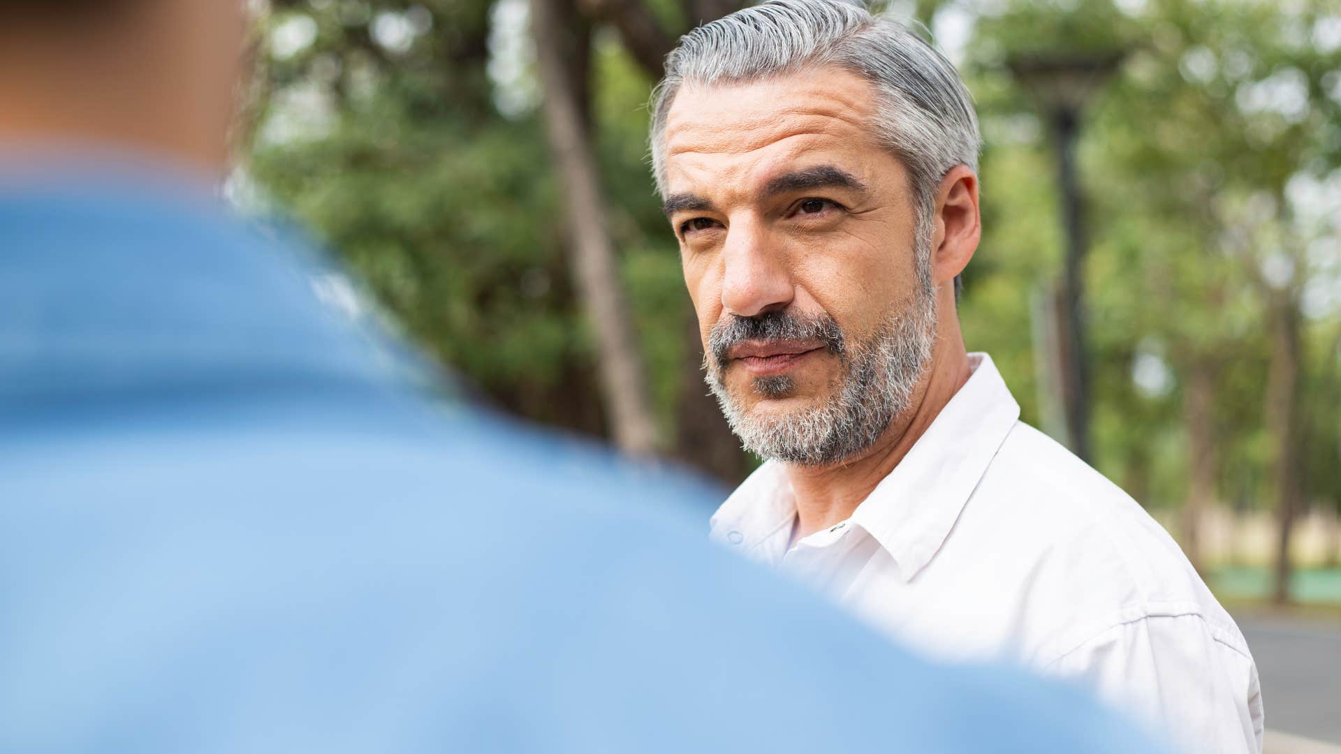 serious man saying i never see my grandkids to his adult son