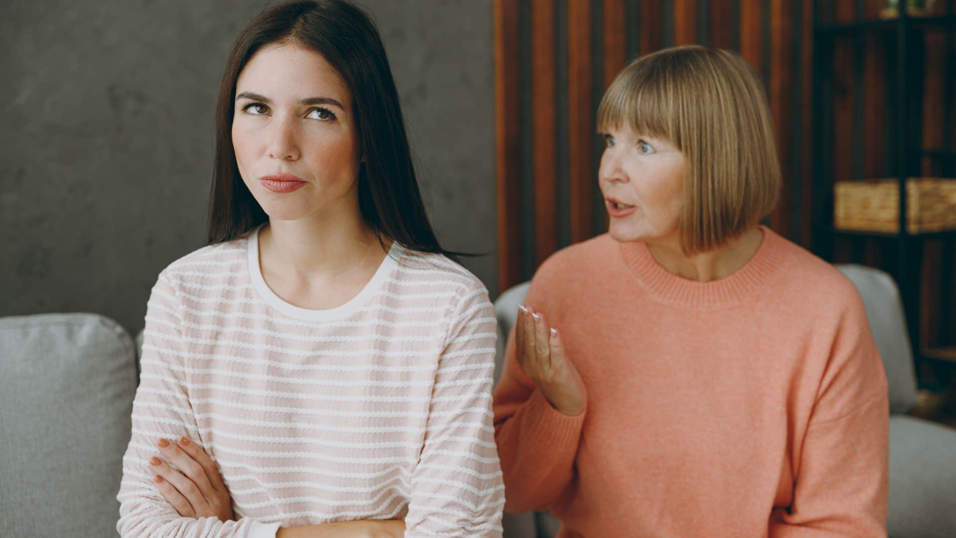 adult woman turned away from mom after telling her you're such a brat