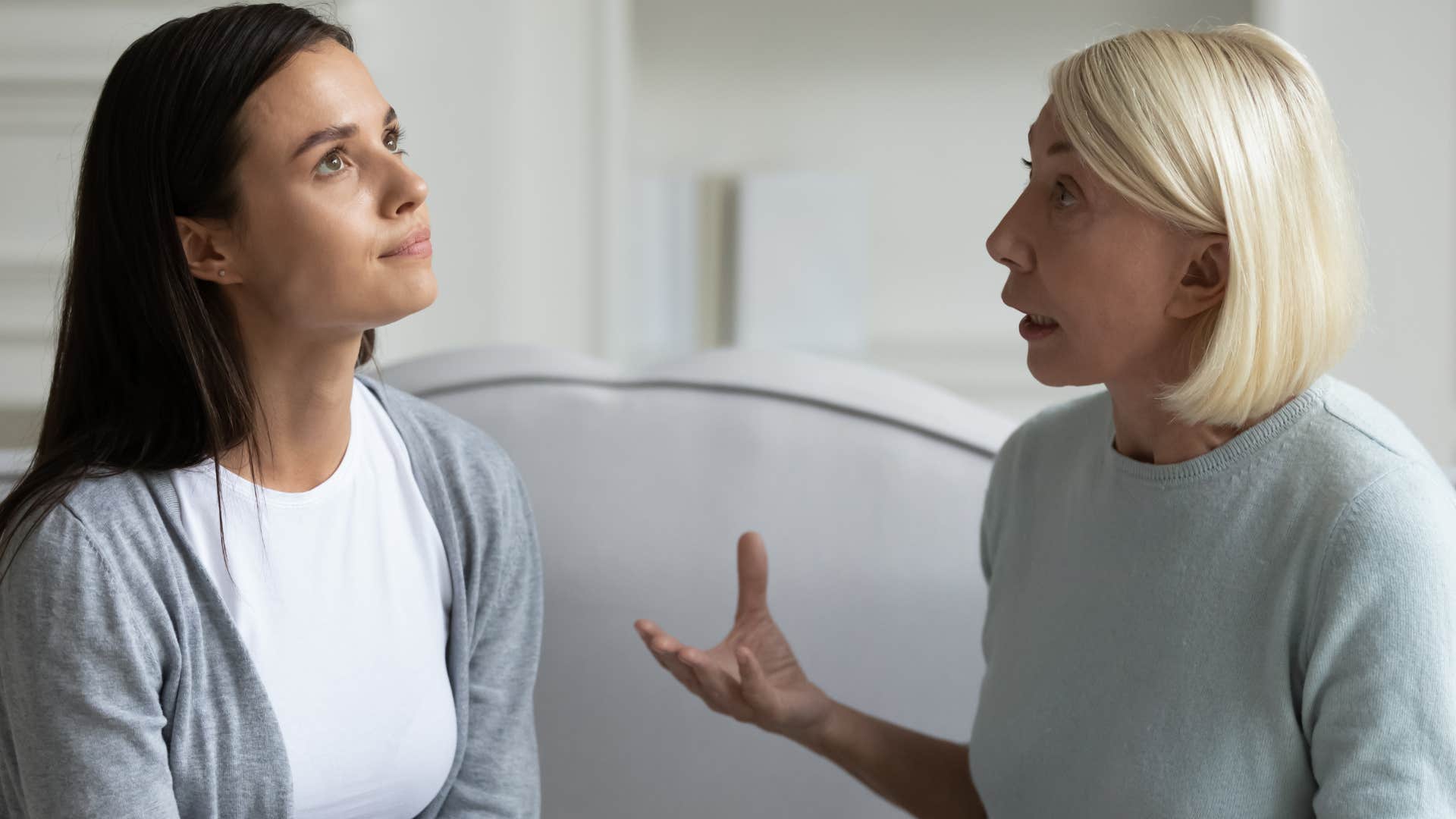 older mom scolding upset daughter saying you're too young to understand