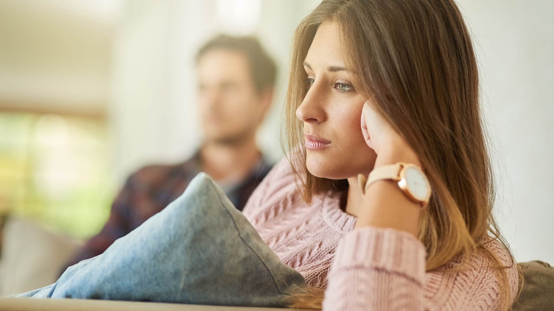 Woman thinking "if you loved me, you'd do it" near her husband.
