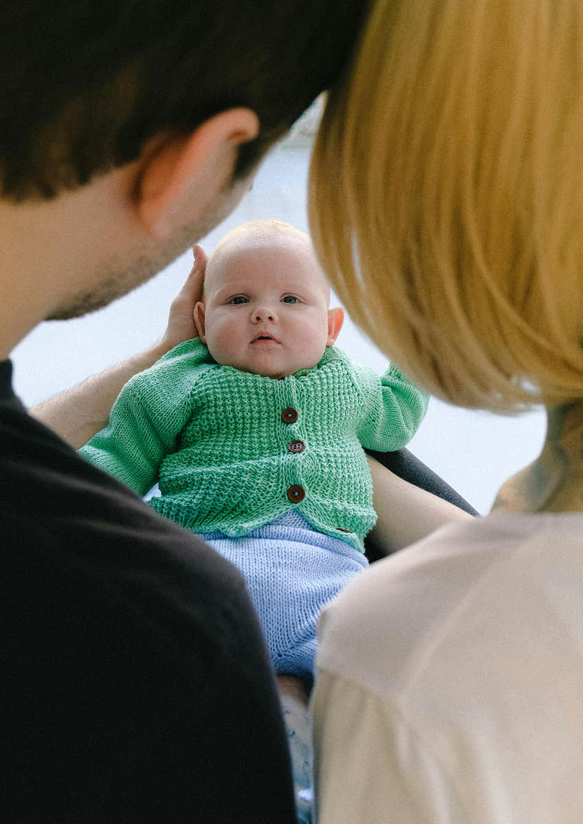 parents holding the baby boy they love