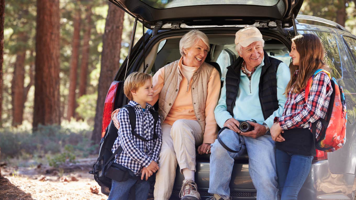 grandparents with their grandkids sitting in the back of the car