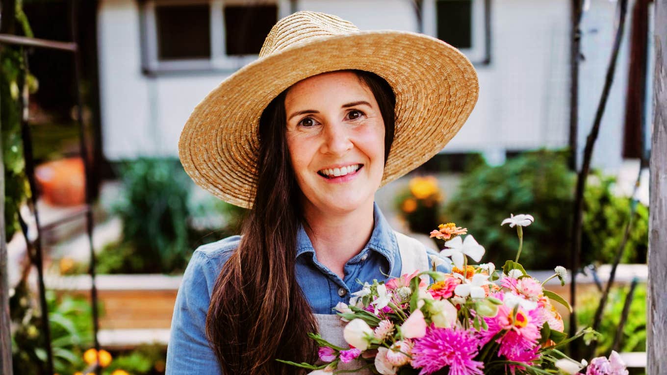 Happy gardener holding a fresh flower bouquet showing small things people do on their own time and habits of introverts.