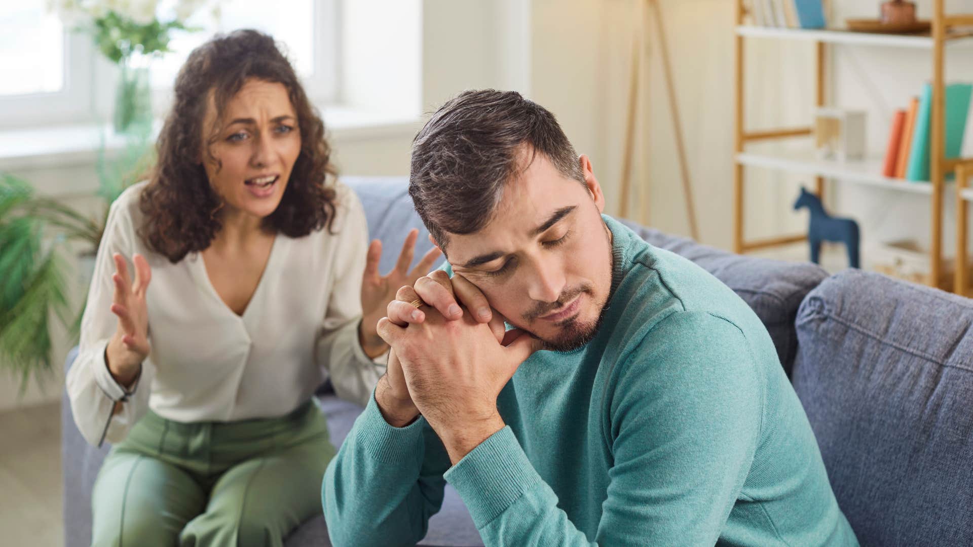 man sighing as his wife tells him about her day