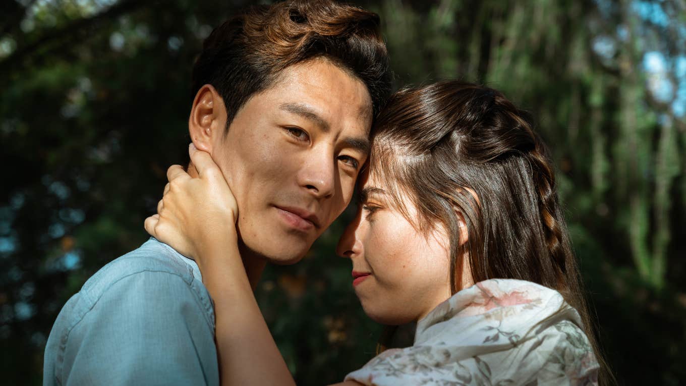 man falling out of love with partner smiling hugging her