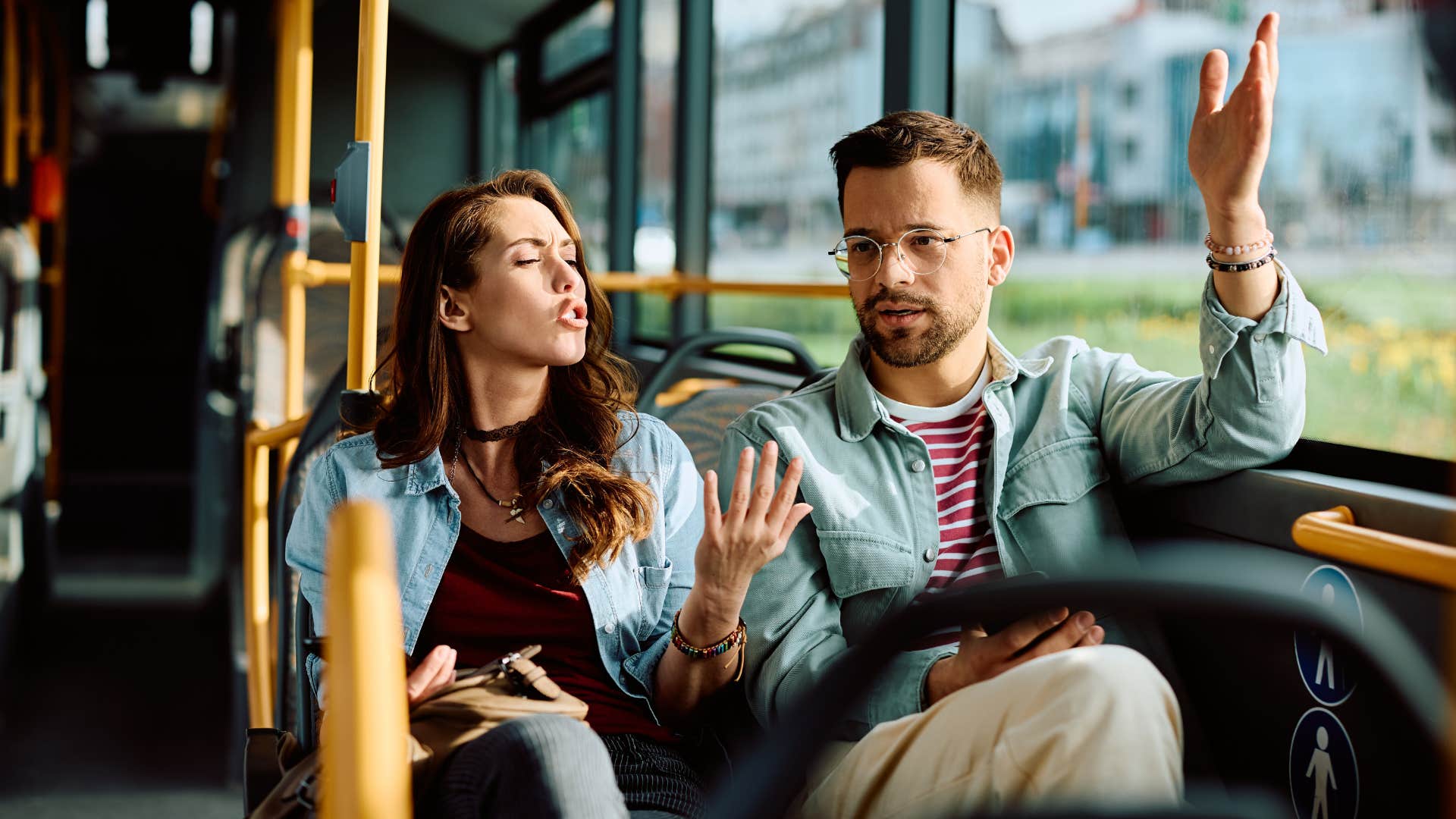 man and woman on bus arguing as he's being defensive instead of understanding