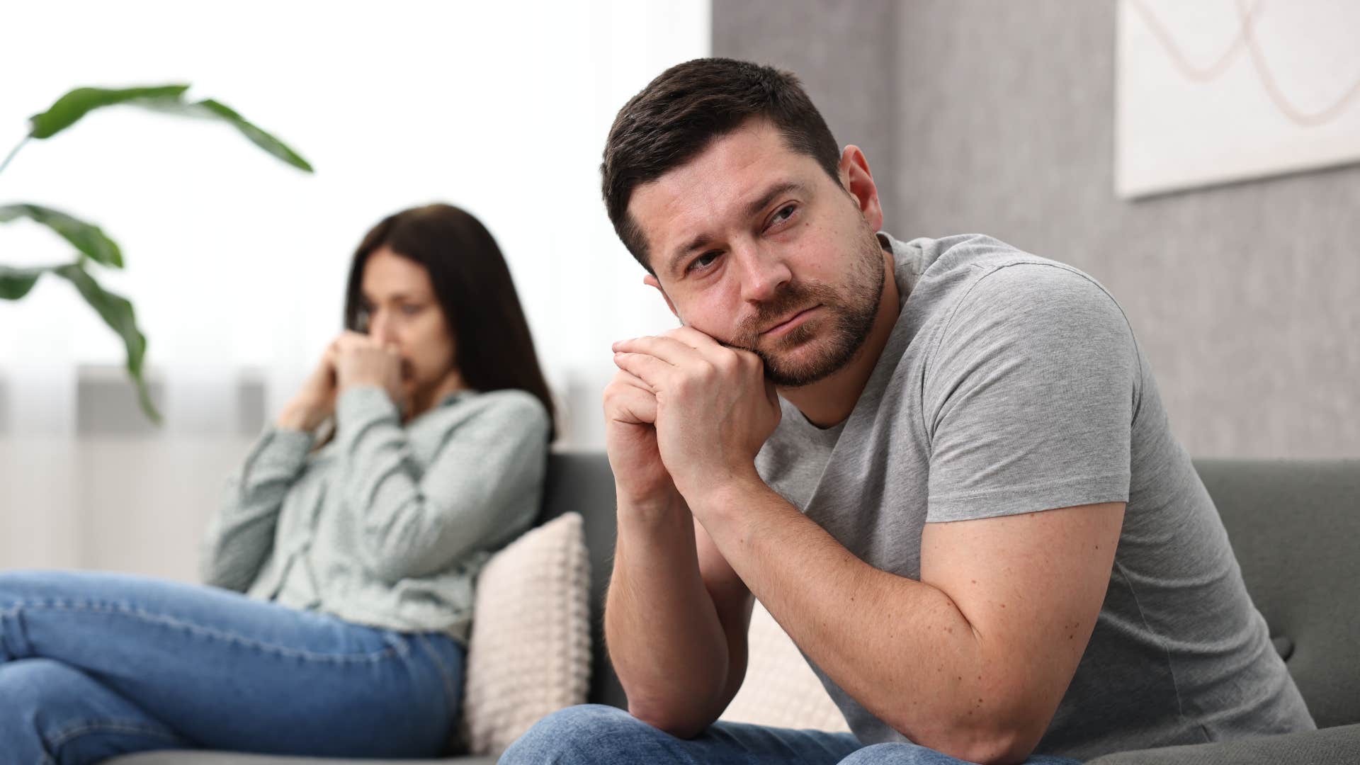 man in gray failing to support her dreams as woman looks upset