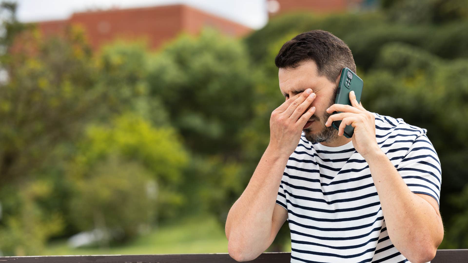 emotionally exhausted man talking on the phone