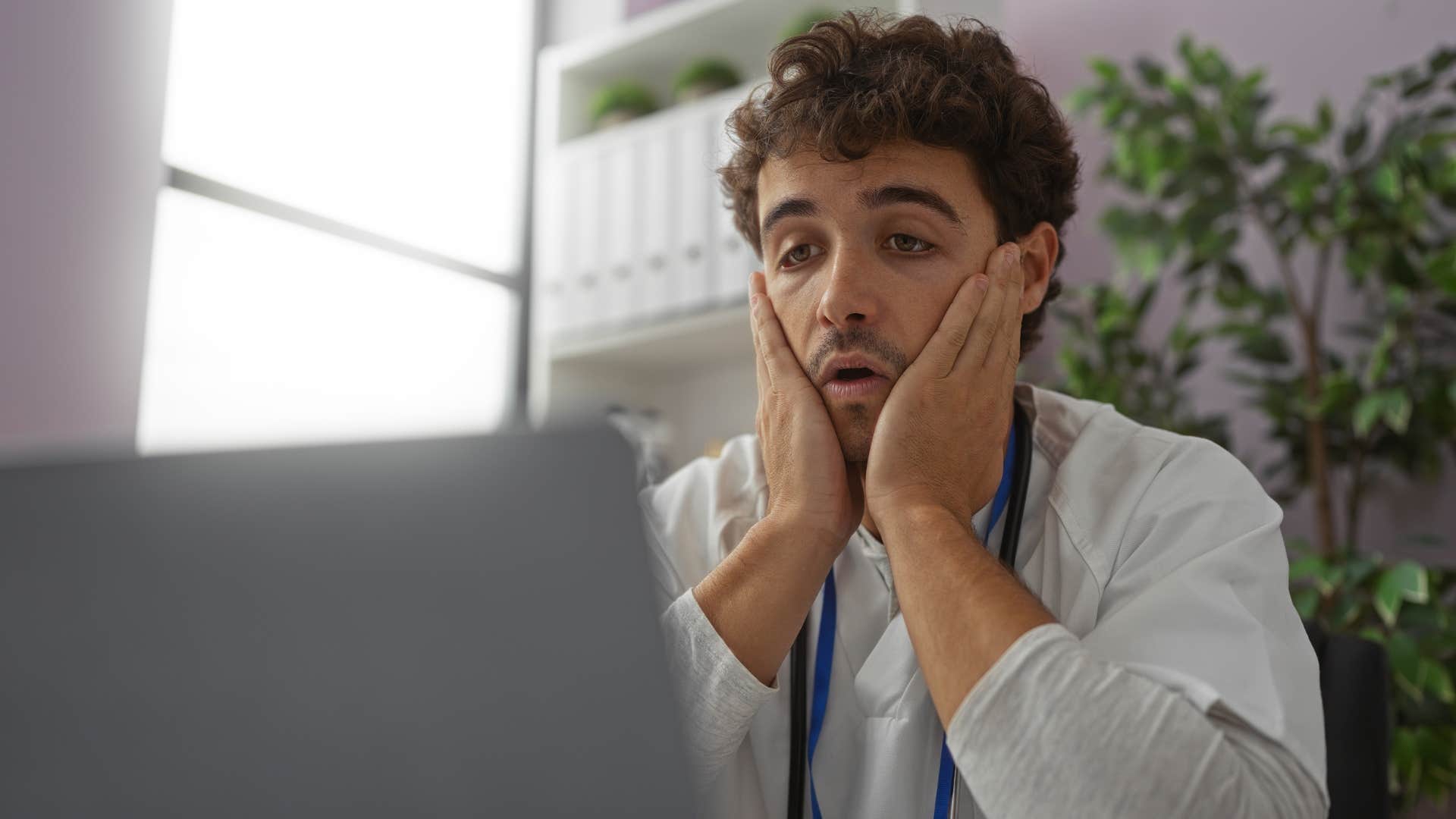 man working feeling overwhelmed
